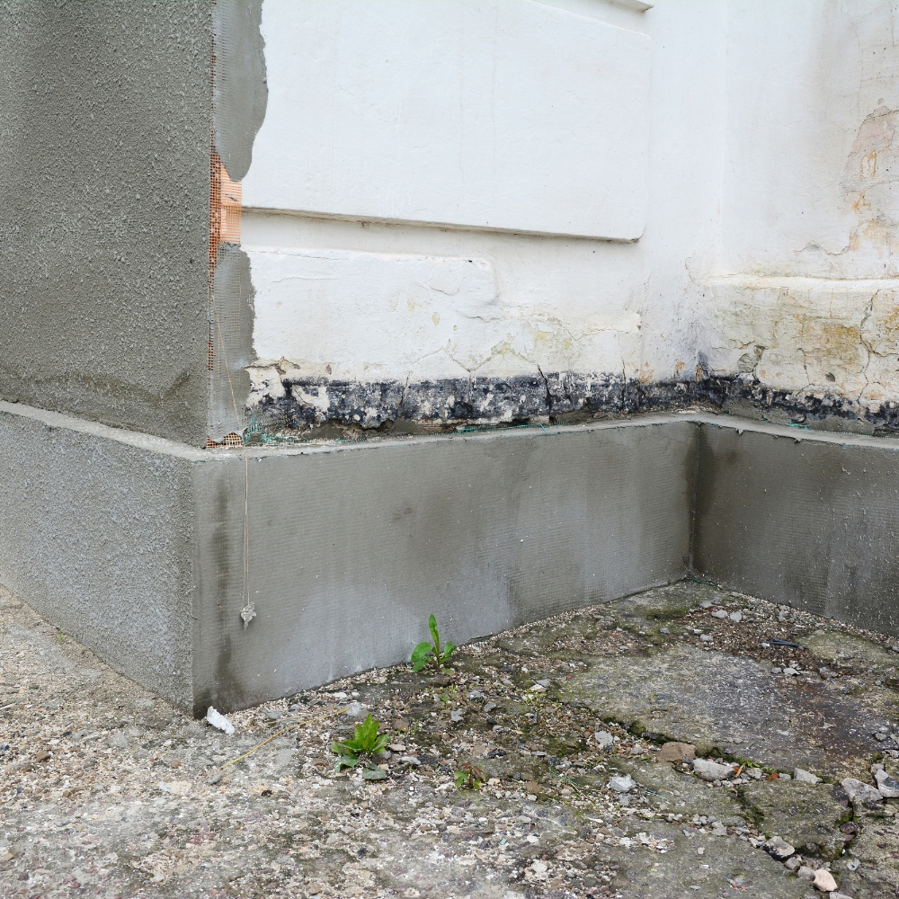 Exterior foundation wall undergoing repair