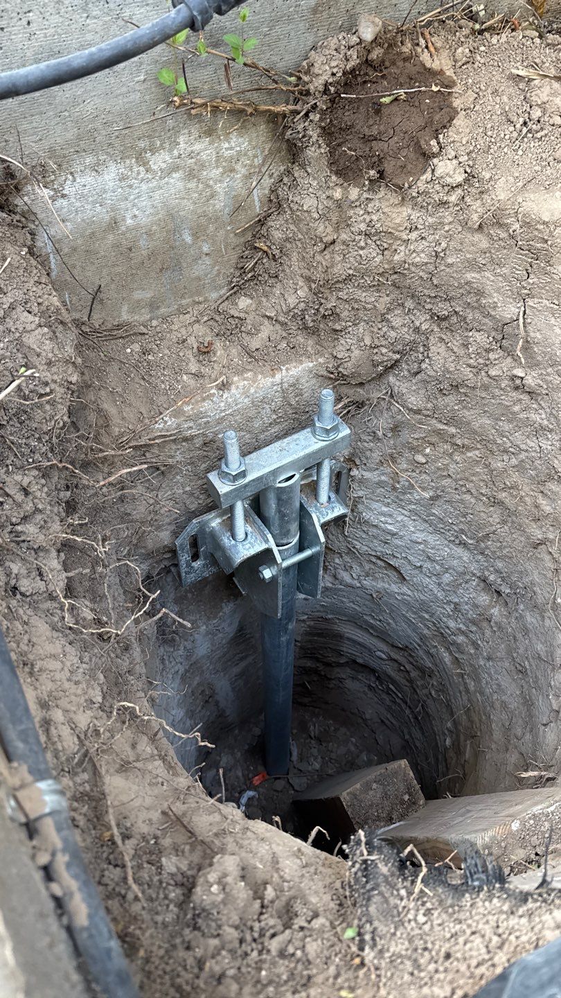 Foundation support hardware installed beside concrete